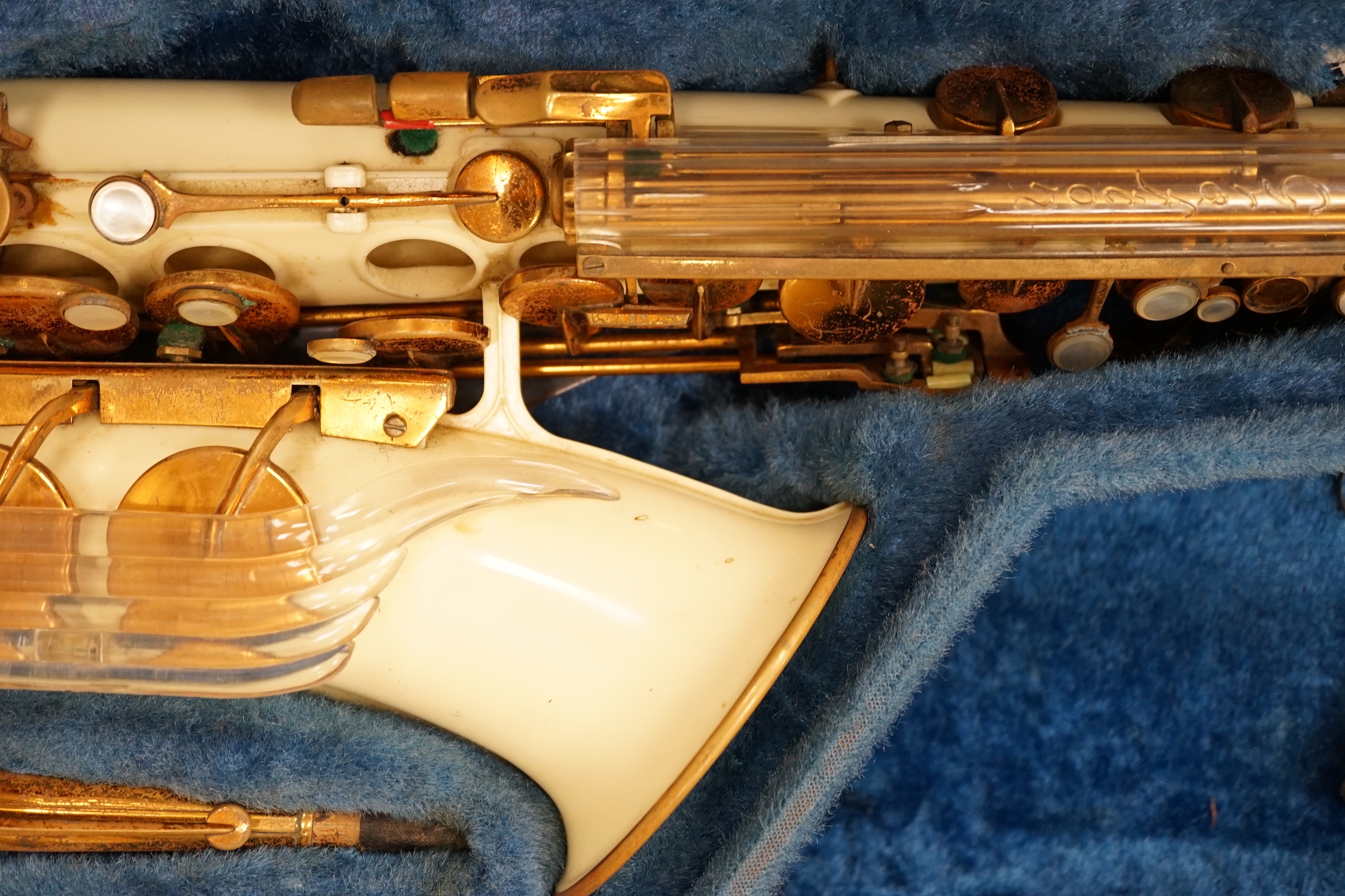 A cased Grafton alto saxophone with cream plastic body and brass plated key work, serial number 13597